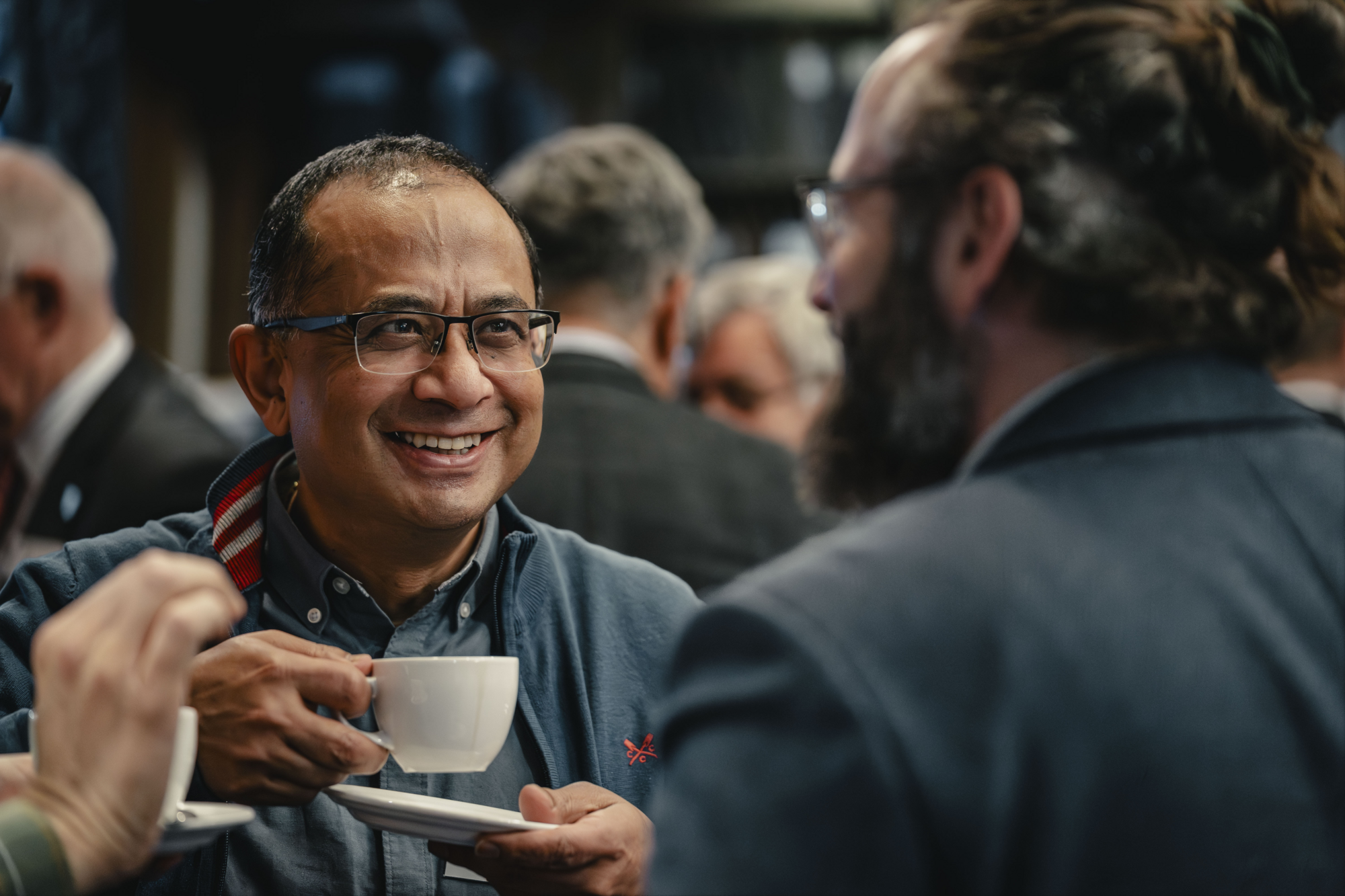 people smiling drinking coffee
